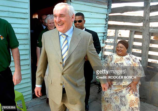 Irish Prime Minister Bertie Ahem shares a joke with Badronesa Van Schalkwyk during a visit to Tafelsig, an impoverished area, about 20km from the...