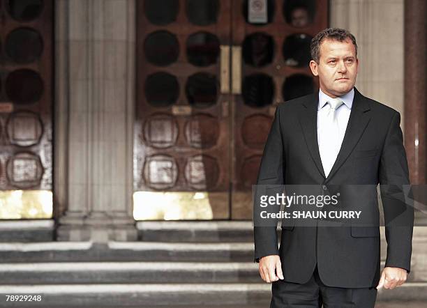 British former butler Paul Burrell poses for the media outside London's High Court, in central London, 14 January 2008, during the inquest into the...