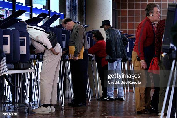 Voters cast their ballots with touch screen voting machines during the first day of early voting in the 2008 presidential primary at the Stephen P....