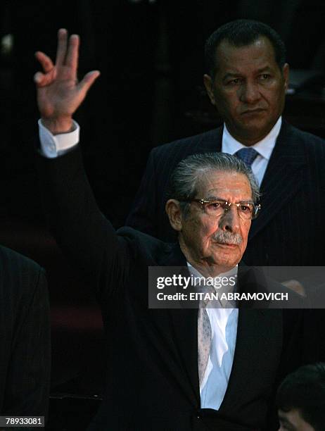 Former dictator Efrain Rios Montt waves after taking the oath during a ceremony at the Guatemalan Congress, 14 January 2008, in Guatemala City....