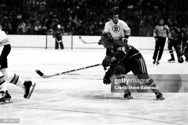 Henri Richard of the Montreal Canadiens goes after the puck against the Boston Bruins.