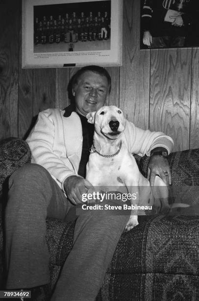 Don Cherry head coach of the Boston Bruins poses with his dog.