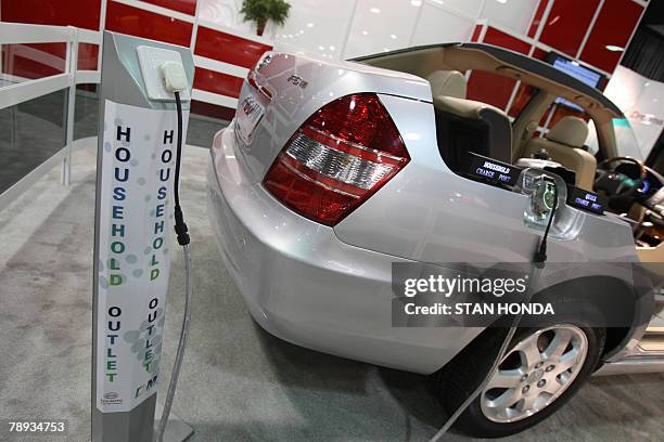 Cut-away demonstration model of the F6 DM car from BYD Company Ltd. Of China showing a place where ordinary household electricity can be plugged in...