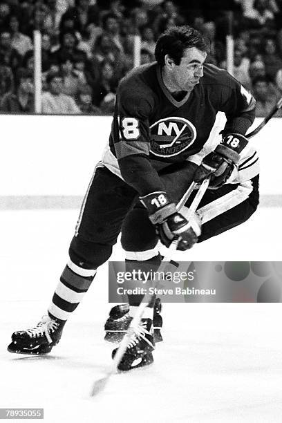 Ed Westfall 318 of the New York Islanders plays against the Boston Bruins .