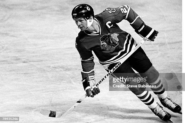 Stan Mikita of the Chicago Blackhawks plays against the Boston Bruins .