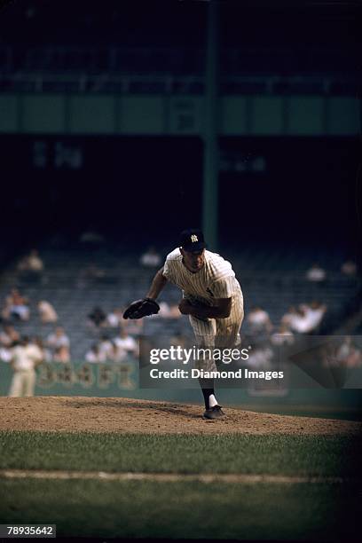 Pitcher Tommy Burne of the New York Yankees follows through on a pitch during a game in 1956 at Yankee Stadium in New York, New York. Tommy...