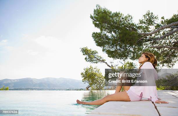 woman relaxing by infinity pool. - marseille people stock pictures, royalty-free photos & images