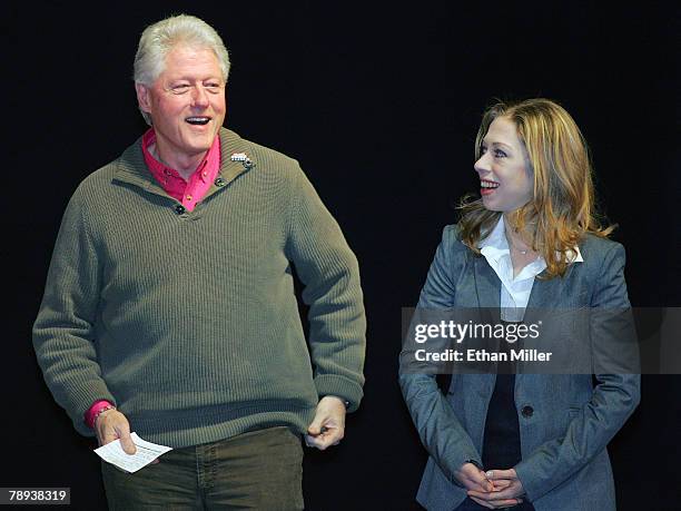 Former U.S. President Bill Clinton smiles alongside his daughter Chelsea Clinton as he waits to be introduced at Green Valley High School to campaign...