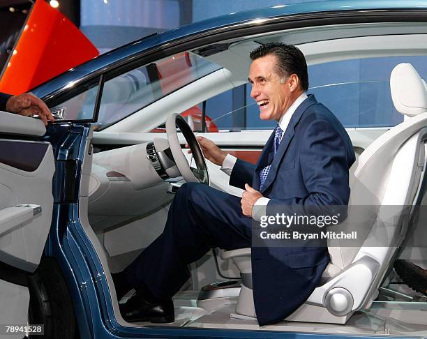 Republican presidential hopeful and former Massachusetts Gov. Mitt Romney sits in the Chrysler Eco-Voyager concept car as he tours the show floor at...