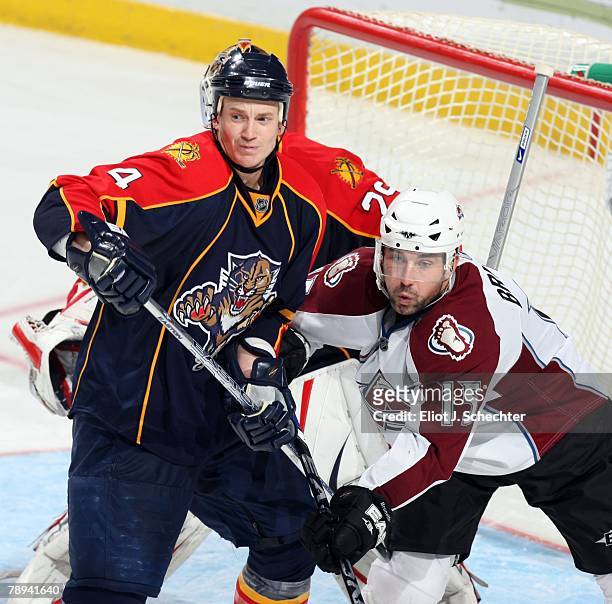 Jay Bouwmeester of the Florida Panthers shoves Andrew Brunette of the Colorado Avalanche at the Bank Atlantic Center on January 13, 2008 in Sunrise,...