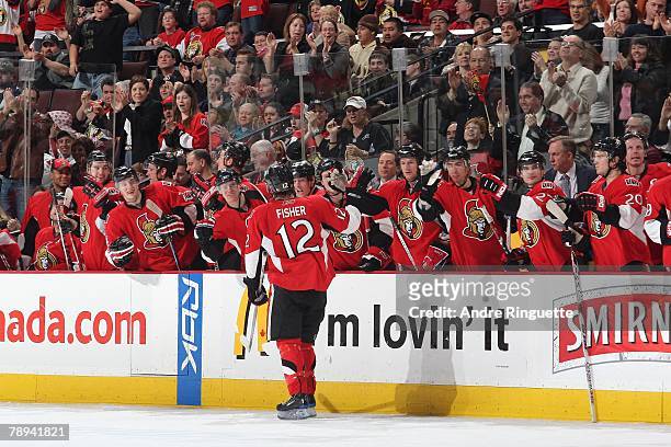 Mike Fisher of the Ottawa Senators celebrates his shootout goal against the Buffalo Sabres at the players' bench at Scotiabank Place on January 10,...