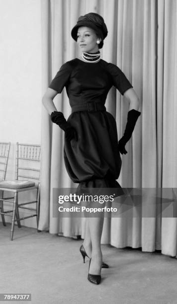 Fashion, London, 2nd September 1959, A model wears an outfit from the Christian Dior "Winter Collection" , an amber print satin "Sheath" dress
