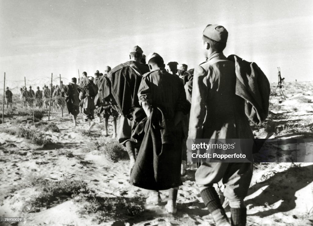 War and Conflict. World War Two. North Africa. pic: circa 1941. Italian soldiers captured during the battle of El Alamein marched off into captivity.