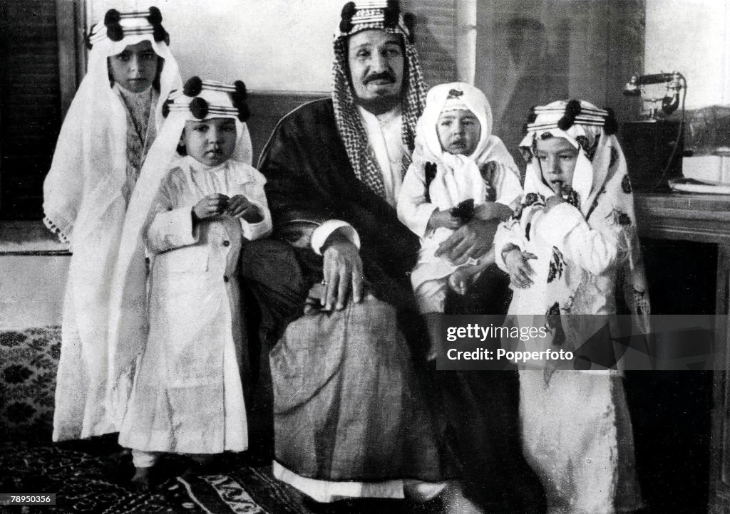 King Ibn Saud, of Suadi Arabia. (1880-1953), pictured with his four grandchildren. 1935.
