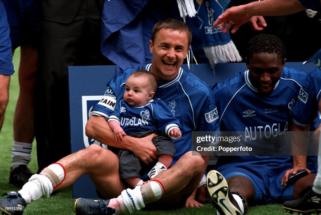 20th May 2000. Wembley, London. AXA FA Cup Final. Chelsea 1 v Aston Villa 0. The Chelsea captain Dennis Wise with his baby son Henry, during the celebrations with Celestine Babayaro, on right.