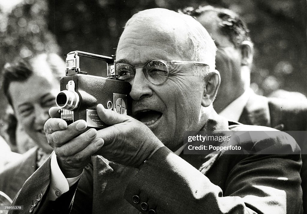 Politics. Personalities. USA. pic: 1948. Washington. President Harry S. Truman tries out a miniature movie camera, presented to him by the White House Press Corps. President Truman (1884-1972) became the 33rd President of the United States 1945-1953.