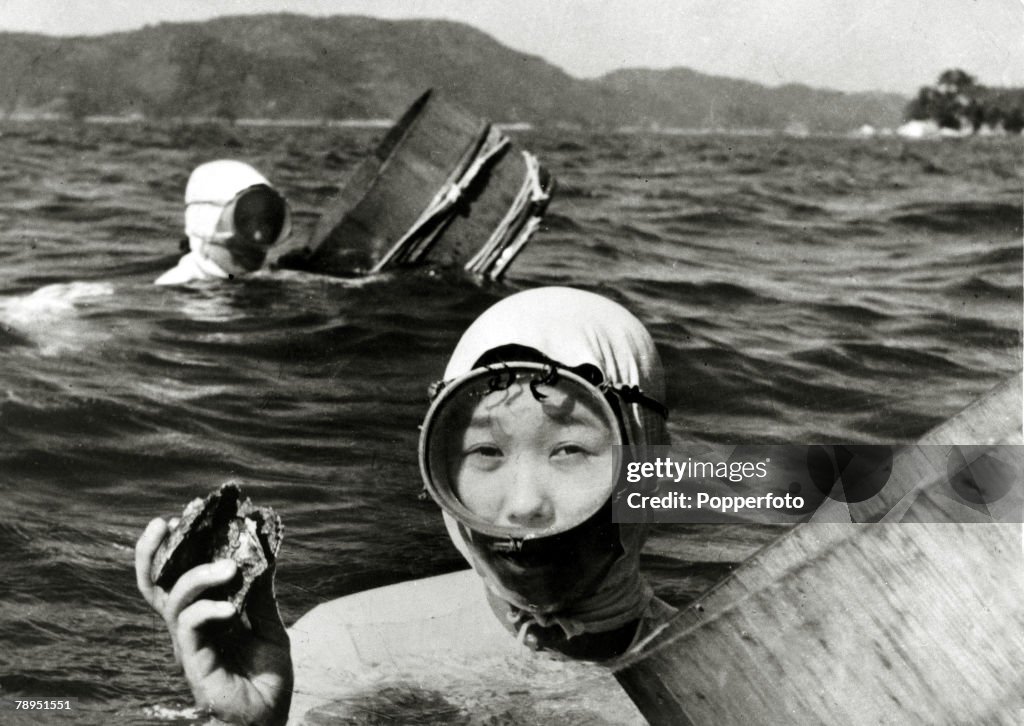 Japan. Professions. pic: 1959. Japanese girl divers who collect oysters from the sea and river estuaries pictured at work, with the containers in which oysters which hold the cultured pearls are stored.