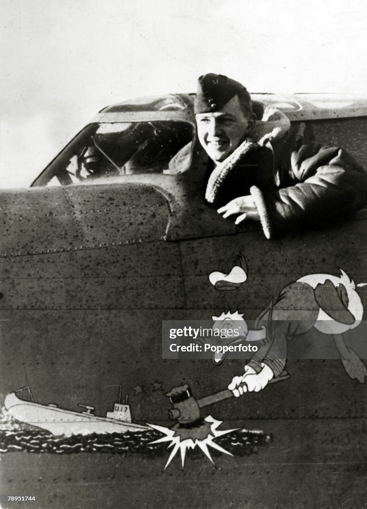 War and Conflict. World War Two. pic: circa 1942. A pilot of British Coastal Command at the cockpit window as his plane shows an amusing sketch of Donald Duck battering a U-boat.