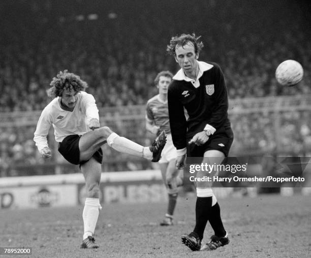 Referee George Courtney tries to avoid a shot from Terry McDermott of Liverpool during the Football League Division One match between Nottingham...
