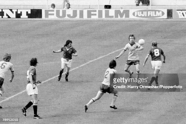 David Price of Arsenal and Jimmy Greenhoff of Manchester United move towards the ball in the penalty area during the FA Cup Final at Wembley Stadium...