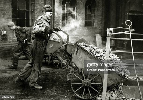 War and Conflict, Post World War Two, pic: 1946, England, A German prisoner of war working at the gas works at Slough, emptying coke down a chute