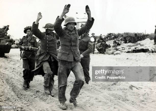 War and Conflict, World War Two, pic: June 1944, Western Front, German prisoners being marched along the beach during the Normandy fighting after D...