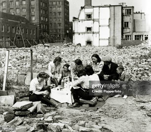 War and Conflict, World War Two, Air Raids, pic: June 1942, Great Britain, A group of people sit amongst the rubble in Chelsea, London to have a...