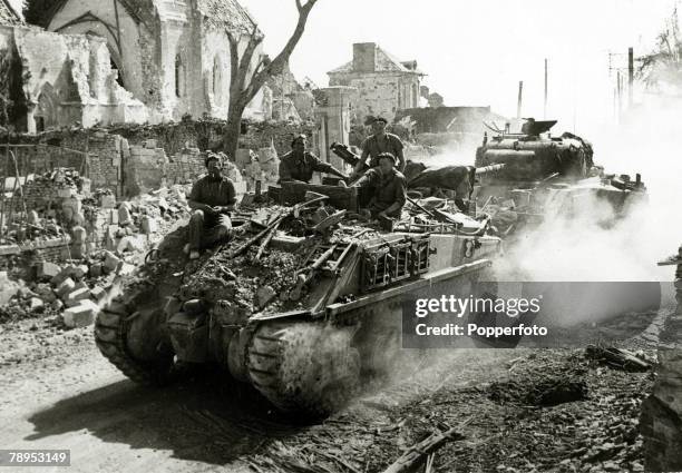 War and Conflict, World War Two, , Invasion of France, pic: June 1944, An Allied Sherman recovery tank towing a crippled Sherman through a ruined...