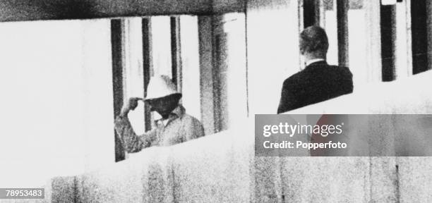 An International Olympic Committee member talks to an Arab guerilla of the "Black September" movement on a balcony in the Olympic Village in Munich,...