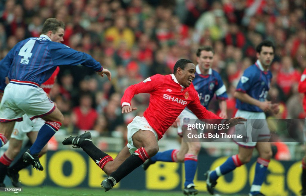 Sport. Football. pic: 10th April 1994. FA. Cup Semi-Final at Wembley. Manchester United 1 v Oldham Athletic 1 aet. Manchester United's Paul Ince flies through the air as Oldham players look on.