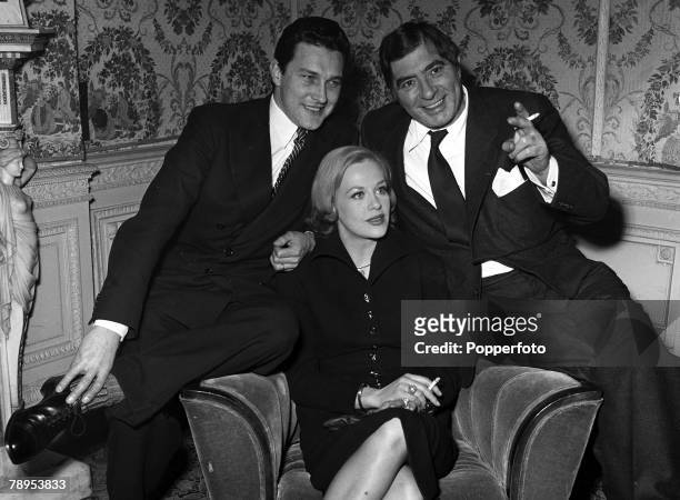 German-born actress Hildegard Knef sits between costars Robert Newton and Terence Morgan at a reception in London held for the George Minter and Noel...
