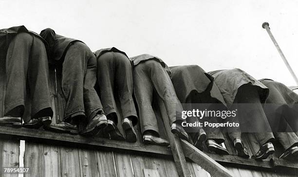 12th October 1935, Division 1, Chelsea v Arsenal, at Stamford Bridge, Determined fans watching from a precarious position on a wooden fence as they...