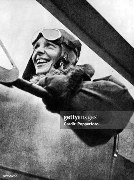 American aviation pioneer Miss Amelia Earhart 1898 - 1937, the first woman to fly across the Atlantic Ocean, pictured in her plane before a flight