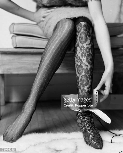 Fashion, London, England A model wearing a comtempary lace stocking contrasts with a black lace stocking and shoe from the era circa 1913