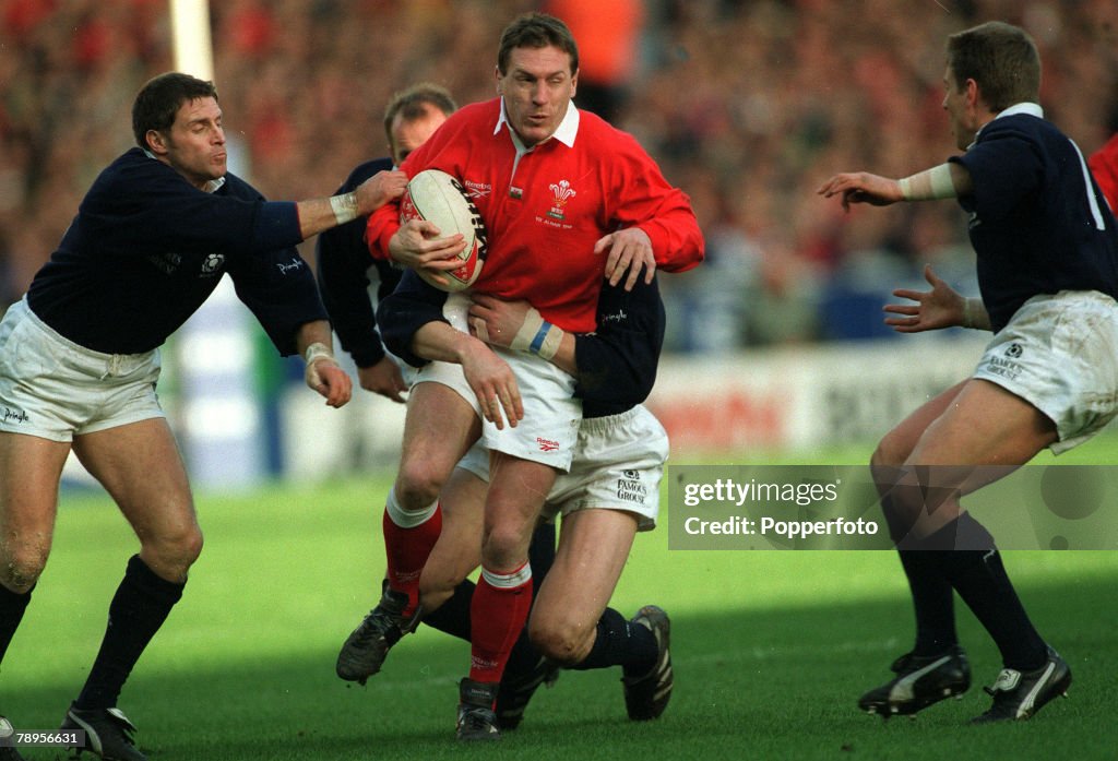 Sport. Rugby Union International. pic: 7th March 1998. Wembley, London, England. Wales 19 v Scotland 13. Wales' centre Allan Bateman on the attack as Scotland's Alan Tait, left, tries to grab him.