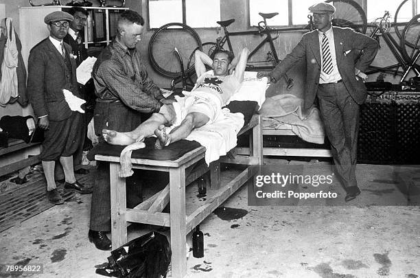 Olympic Games, Amsterdam, Holland, Canada's Percy Williams receives a massage from trainer Bob Grainger