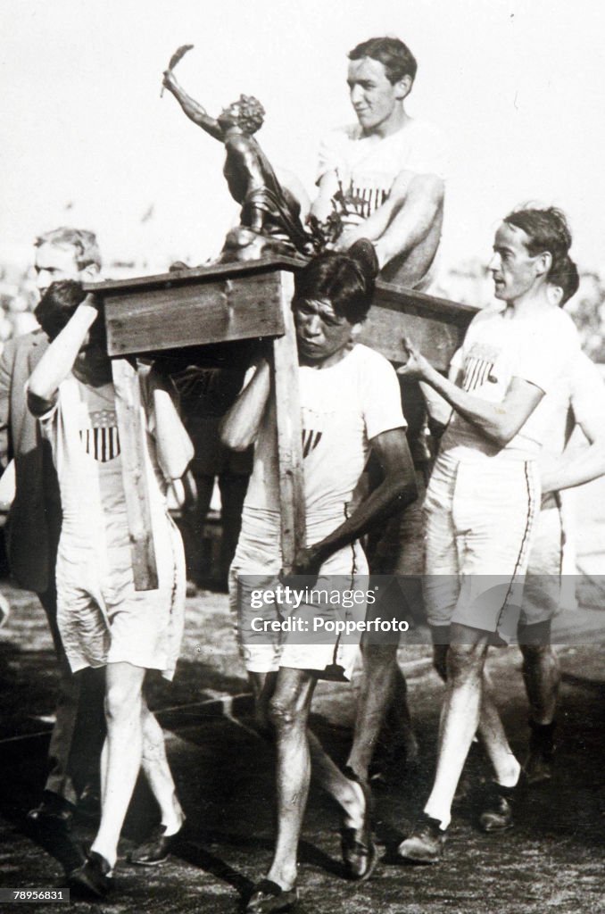 1908 Olympic Games. London, England. Marathon. USA's J.J Hayes, who won the gold medal, is carried on a table with the trophy after the race.