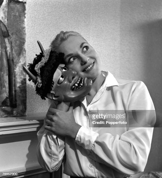 England Australian actress Diane Cilento is pictured holding a mask
