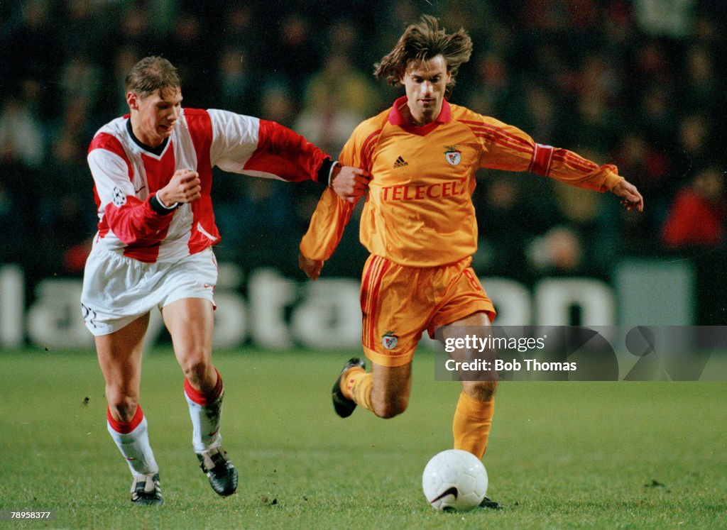 Sport. Football. pic: 9th December 1998. UEFA. Champions League. PSV.Eindhoven 2 v Benfica 2. Benfica's Joao Pinto is held back by PSV. Eindhoven's Theo Lucius.