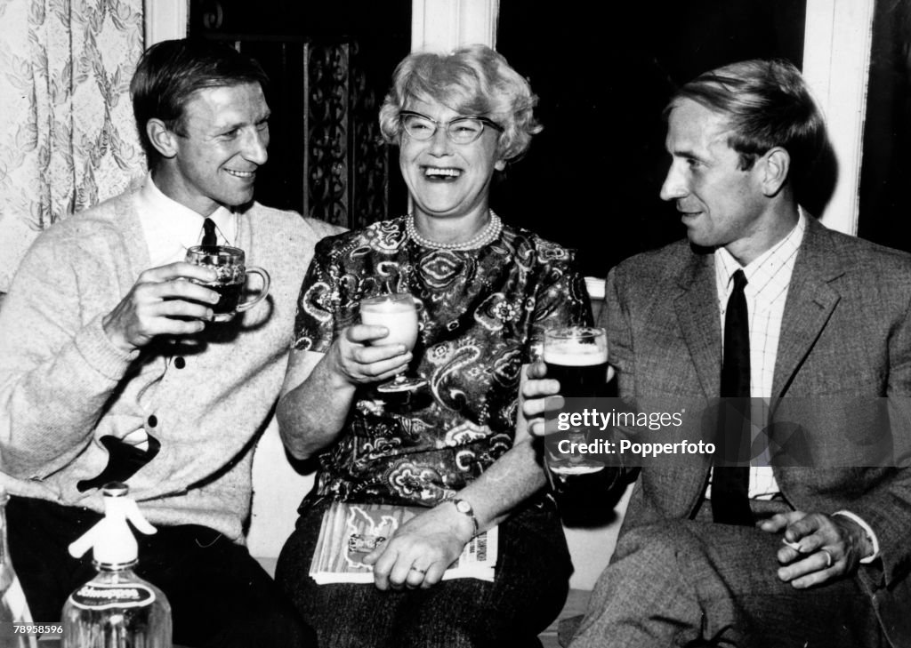 Sport. Football. pic: 28th July 1966. England internationals Jack, left, and Bobby Charlton enjoy a celebration drink with their mother Cissie after the World Cup Semi-Final win over Portugal at Wembley.