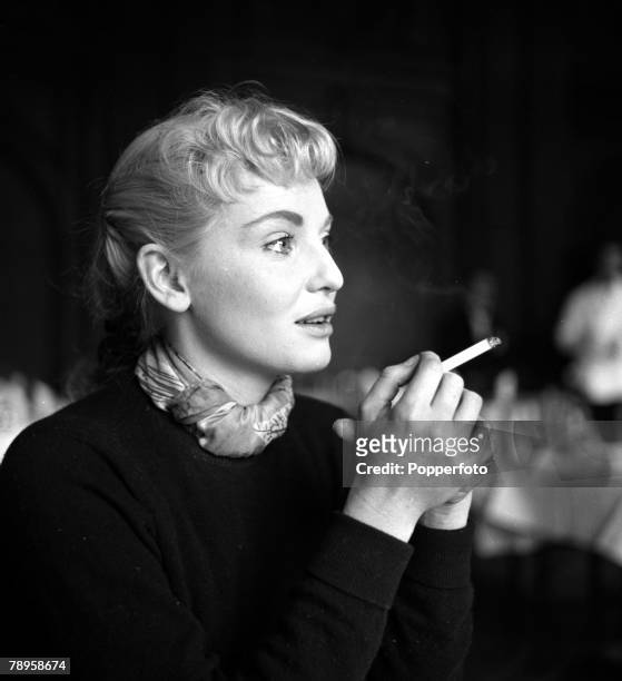 England Australian actress Diane Cilento is pictured smoking a cigarette