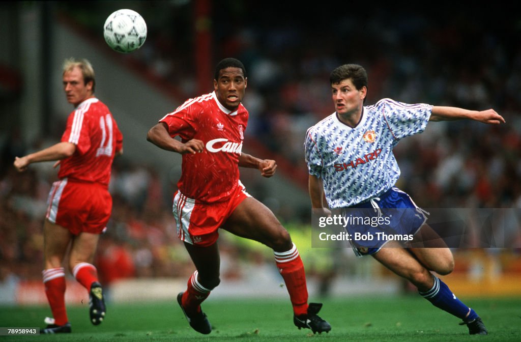 Sport. Football. pic: 16th September 1990. Division 1. Liverpool 4 v Manchester United 0. Liverpool's John Barnes, left, and Manchester United defender Dennis Irwin keep their eyes on the ball.