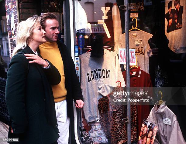 Young couple window shopping in London