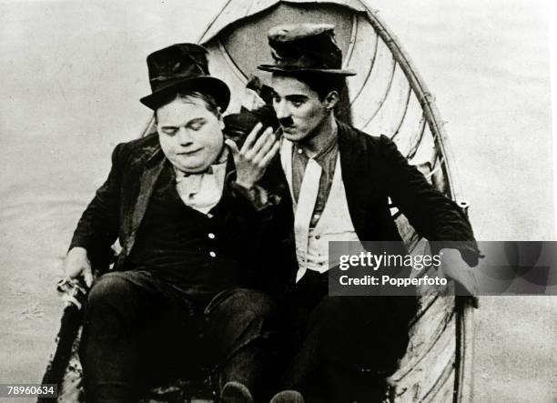 Cinema Personalities, pic: circa 1915, American comedy silent film star Roscoe "Fatty" Arbuckle, left, pictured with Charlie Chaplin in a scene