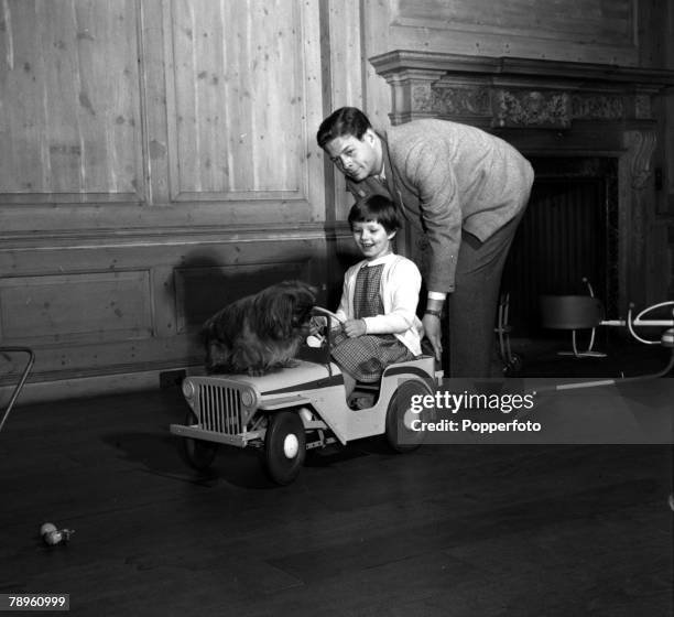 England Ex-King Michael of Romania is pictured pushing his eldest daughter Princess Margaret and their pet dog in a toy car
