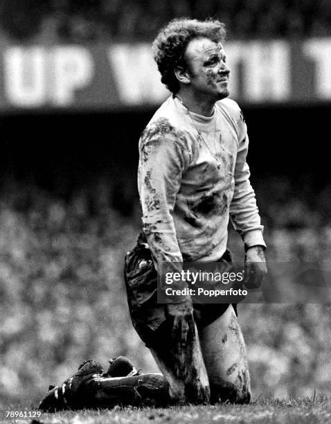 1st April 1972, Division 1, Derby County v Leeds United at the Baseball Ground, Leeds United captain Billy Bremner is pictured on his knees covered...