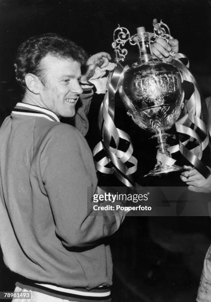 Leeds United captain Billy Bremner holding the First Division Championship trophy