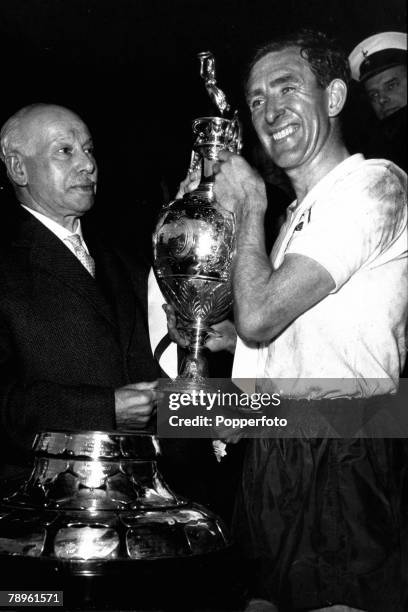 29th April 1961, Division 1, Tottenham Hotspur captain Danny Blanchflower receives the Championship trophy from Joe Richards, the President of the...