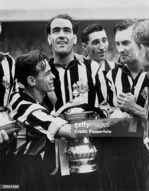 28th April 1951, FA, Cup Final at Wembley, Newcastle United 2 v Blackpool 0, Newcastle United captain Joe Harvey holds the trophy as Ernie Taylor...