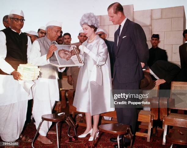 Royal Tour to India, Queen Elizabeth II and Prince Philip, the Duke of Edinburgh, are pictured visiting the Gandhi shrine at Raj Ghat